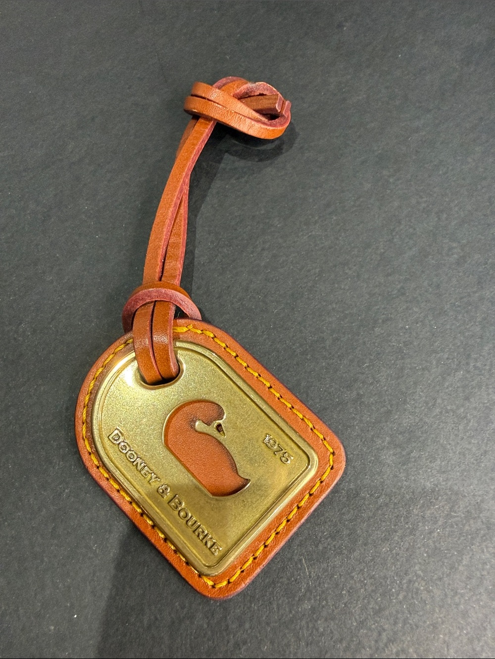 Dooney & Bourke Brown Leather and Brass Duck Hang Tag